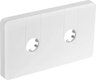 A white, rectangular object with two circular openings, resembling a cassette tape.
