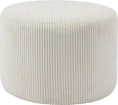 A studio shot of a round, beige ottoman with a corduroy-like texture.
