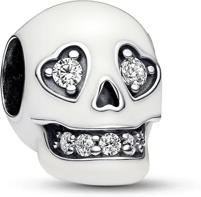 A close-up studio shot of a white skull charm with clear crystal accents.