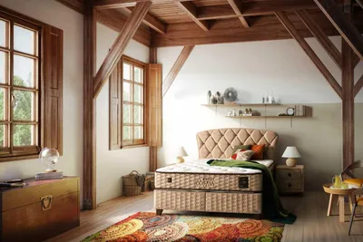 A bedroom with a bed, nightstand, and windows.