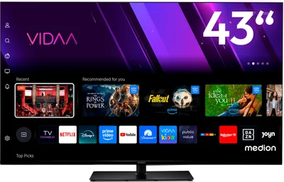 A television screen displaying a smart TV interface with various app icons and promotional content.