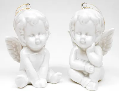 Two white ceramic angel figurines are displayed against a white background.