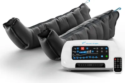 A pair of black compression leg sleeves and a white control unit with a remote control, all on a white background.