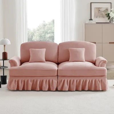 A pink sofa in a well-lit room.