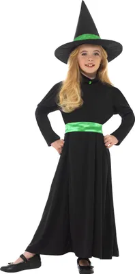 A young girl wearing a witch costume, posing against a white background.