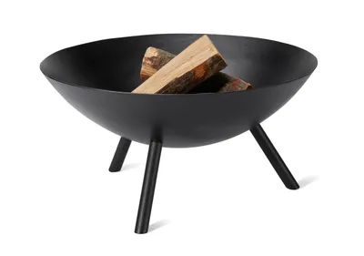 A black metal fire bowl with three legs, containing two pieces of firewood, set against a white background.