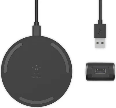 A black wireless charging pad, a USB cable, and a USB power adapter are arranged on a white background.