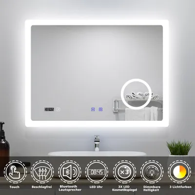A bathroom mirror with integrated LED lighting, a digital clock, and touch controls, shown above a sink.