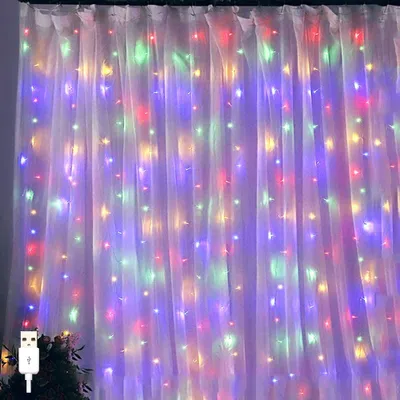 A curtain of lights hanging on a white background, with a USB connector visible on the bottom left.