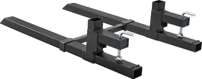 A pair of black metal pallet forks with adjustable stabilizers, shown from a diagonal angle against a white background.