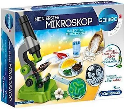 The image shows the packaging of a children's microscope kit, featuring the microscope and various items for scientific exploration.
