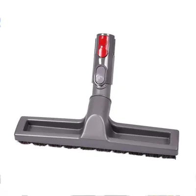 A vacuum cleaner attachment with brushes and red and gray buttons.
