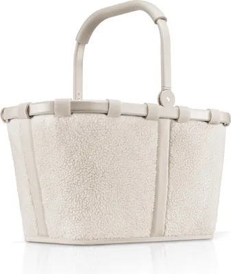 A studio shot of a cream-colored teddy fleece basket bag with a light beige handle and trim.