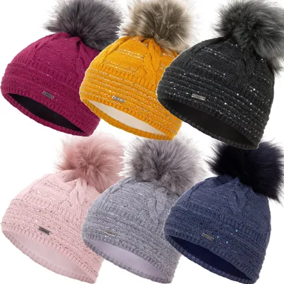 A collage of six winter hats in different colors, each with a faux fur pom-pom.