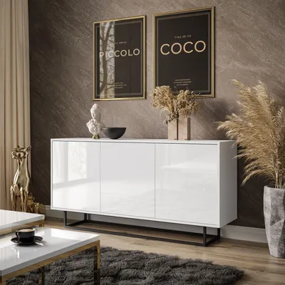 A modern living room setting with a white sideboard, artwork, and decorative items.