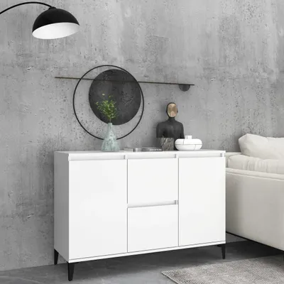 A white sideboard with two drawers and two cabinets in a modern room with a concrete wall.