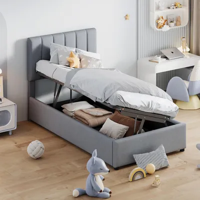 A child's bedroom with a bed that has storage underneath, a desk with a laptop, and toys on the floor.
