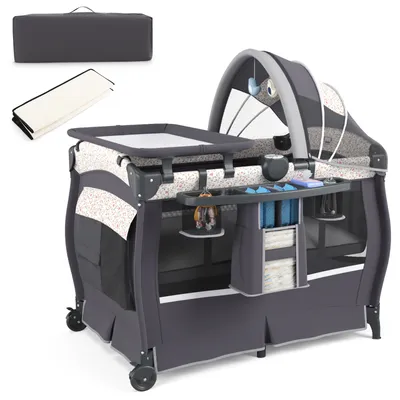 A baby travel crib with accessories, including a changing pad and a carrying case.