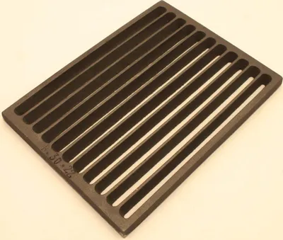 A dark gray cast iron grate with parallel slats is shown from a slightly elevated angle against a light gray background.