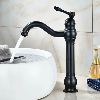 A black faucet is shown in a bathroom setting, with water flowing into a white sink.