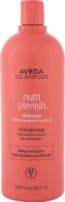 A coral-colored bottle of Aveda Nutri-Plenish Shampoo Deep Moisture.
