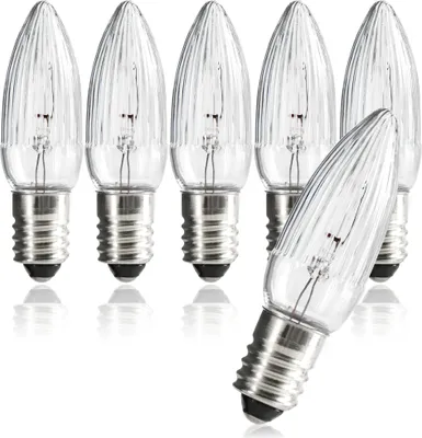 A group of clear, ribbed candle-shaped light bulbs with silver screw bases, arranged on a white background.