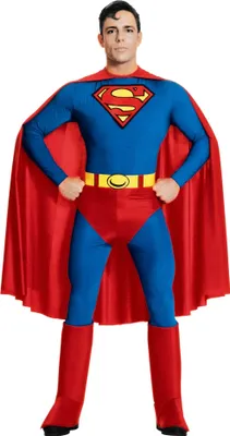 A man dressed as Superman stands facing the camera against a white background.