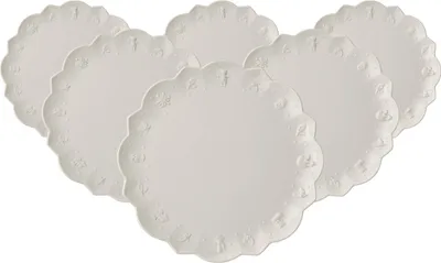 A set of six white plates arranged in a fanned-out pattern on a white background.
