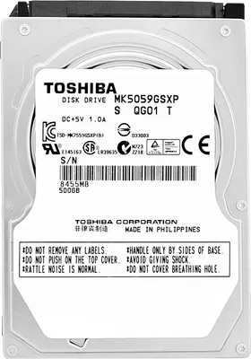 A close-up, top-down view of a Toshiba hard drive with a label containing product information and warnings.