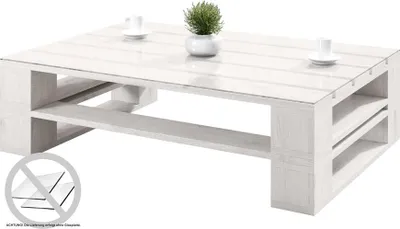 A white pallet coffee table with a plant and two cups on it, set against a white background.