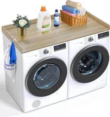 A wooden countertop placed on top of two washing machines.