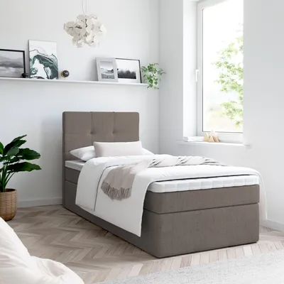 A bedroom scene with a bed, shelf, and window.