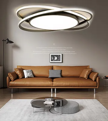 A modern living room with a brown leather sofa, a coffee table, and a stylish ceiling lamp.
