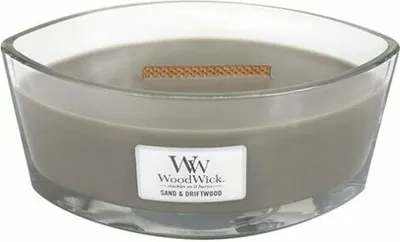 A close-up studio shot of a WoodWick Sand & Driftwood candle in a clear glass container.