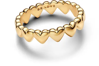 A close-up studio shot of a gold ring with heart shapes.