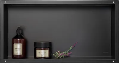 A black shelf with two bottles and a sprig of lavender.