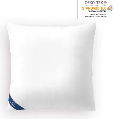 A white pillow is shown against a white background, with certification labels visible.