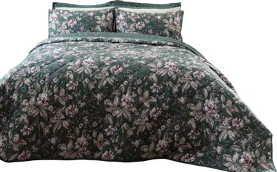 A bed with a floral-patterned duvet and pillows.