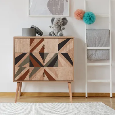 A child's room with a dresser, a ladder, and decorative items.