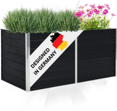 A black planter box filled with green plants and pink flowers, with a diagonal banner showing the German flag and text.
