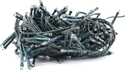 A tangled pile of green string lights with small LED bulbs.