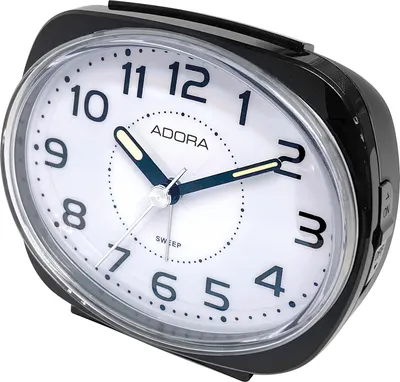 A close-up studio shot of a black and white alarm clock.