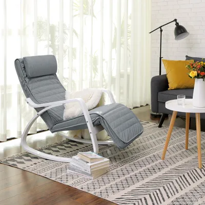 A living room scene with a rocking chair, sofa, and side table.