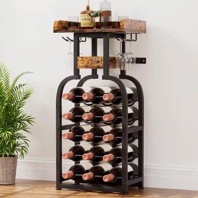 A wine rack filled with wine bottles and glasses, placed next to a potted plant.