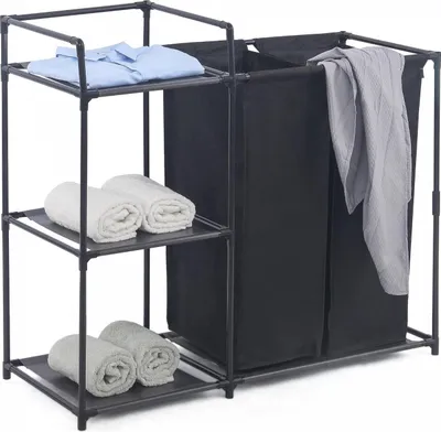 A laundry sorter with shelves and two black fabric bins, displaying folded towels and a blue shirt.