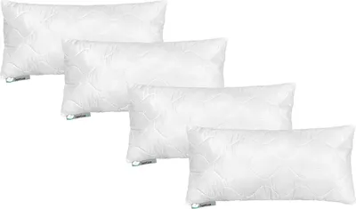 Four white pillows are stacked diagonally on a white background.