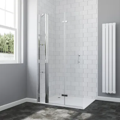 A modern bathroom with a walk-in shower, white subway tile walls, and a vertical radiator.