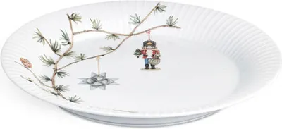 A white plate with a Christmas-themed illustration of a pine branch with ornaments.
