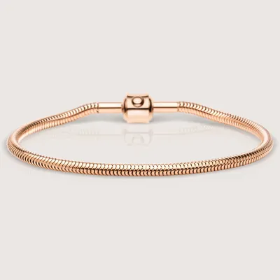 A rose gold colored bracelet with a clasp is shown against a light gray background.