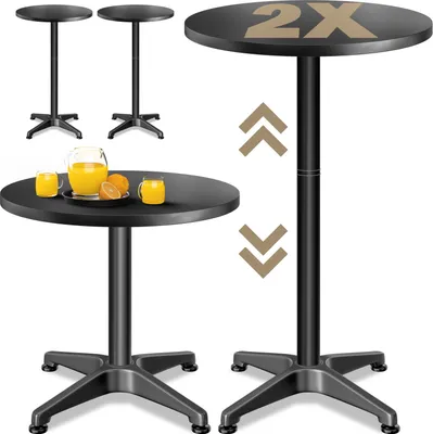 Two black bistro tables are shown, one with a pitcher of orange juice and two glasses on it, and another taller, adjustable table with "2X" printed on its surface.